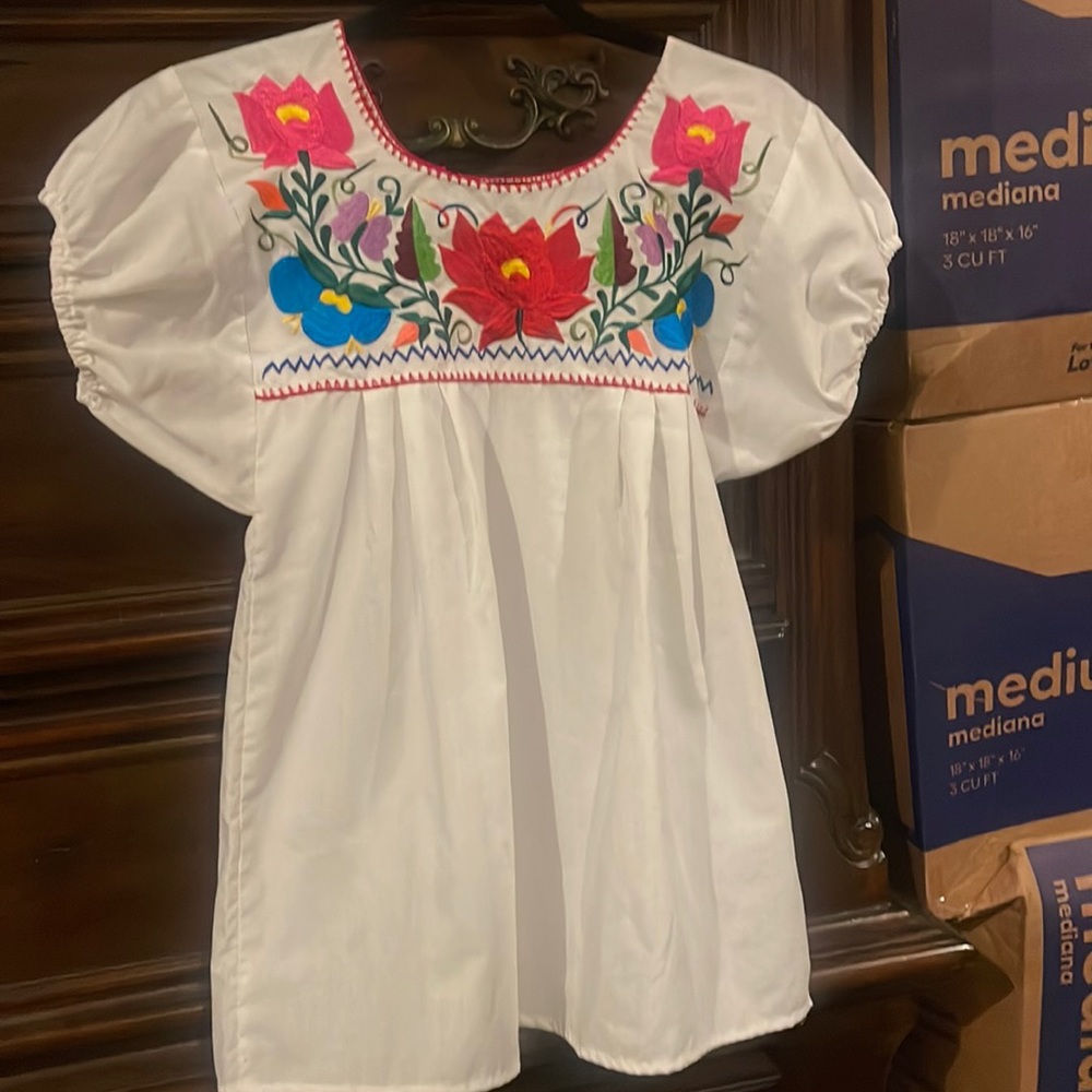 white tunic shirt with embroidered flowers
